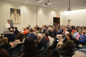 Father Cameron lecture wide shot